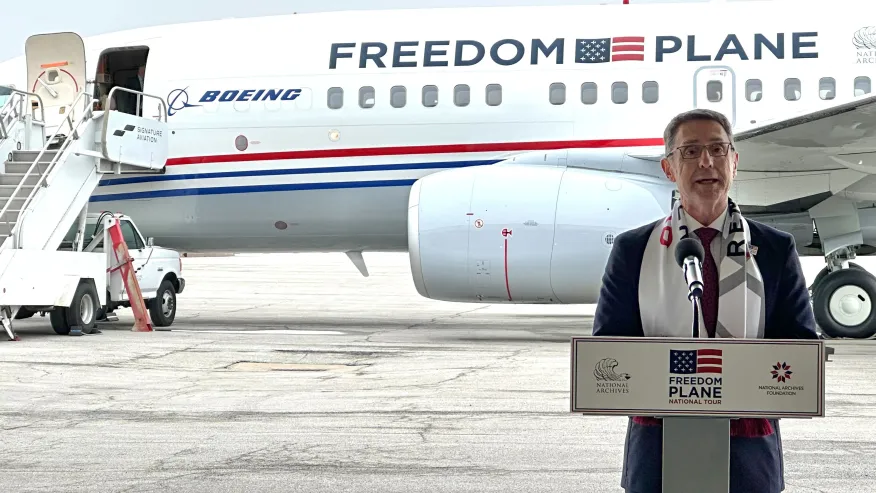 Matthew Naylor speaking in front of the Freedom Plane during the National Archives tour