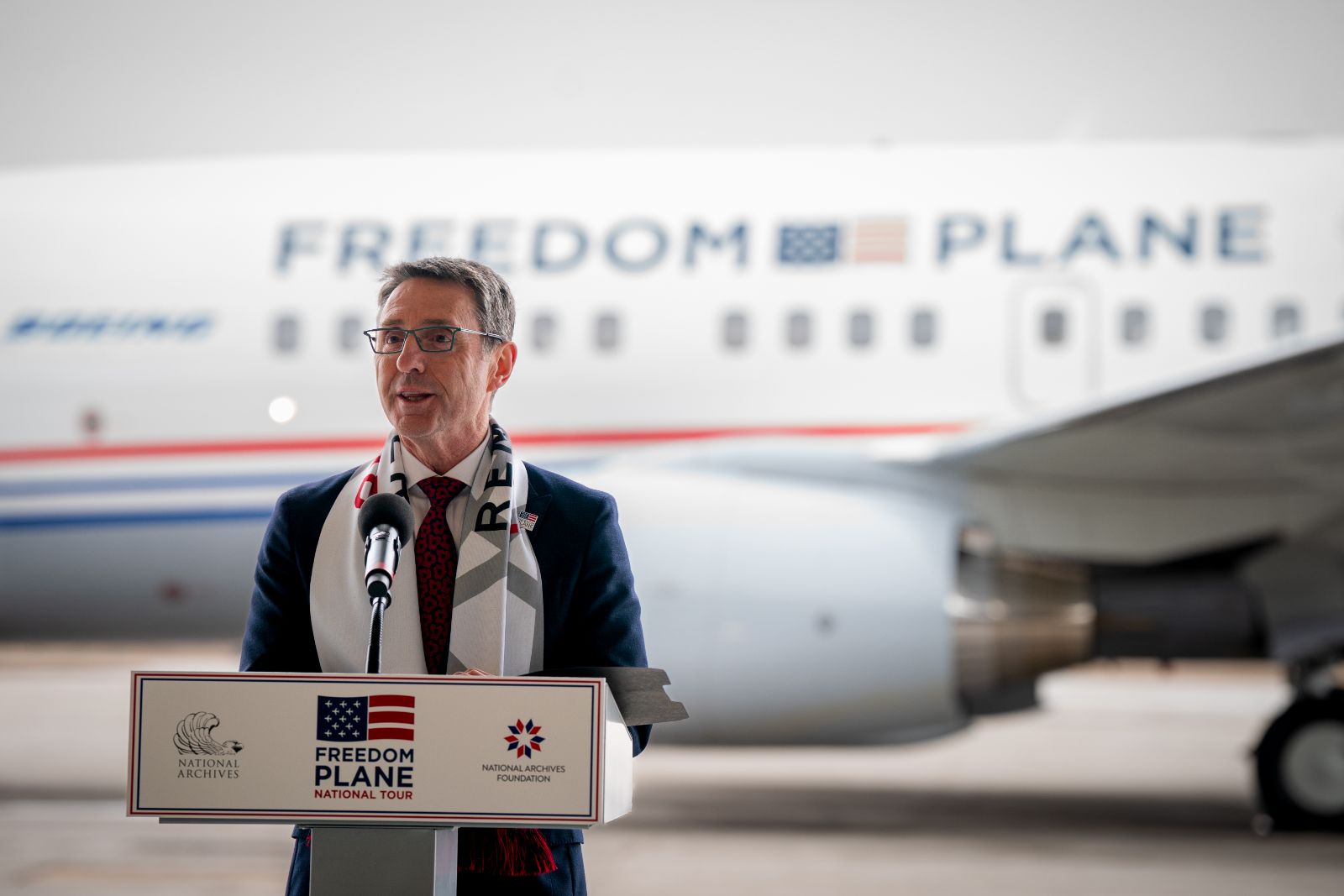 Matthew Naylor speaking at a podium